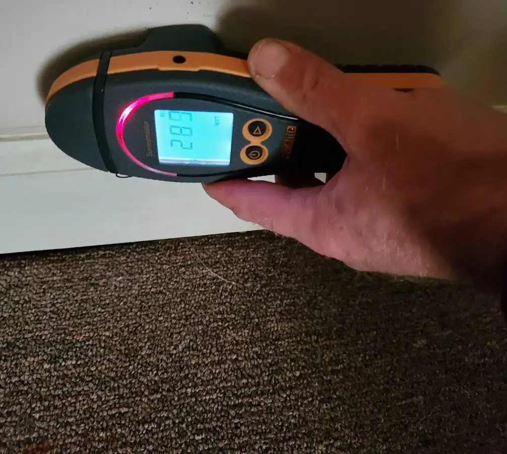 Moisture detection at baseboard during Storm Damage Restoration in Southwick